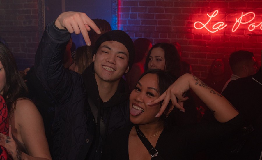 Couple posing for the photographer in a nightclub